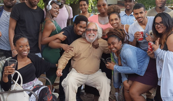 FCG Refugee Centre co-director Francisco Rico Martinez surrounded by community members, smiling into camera