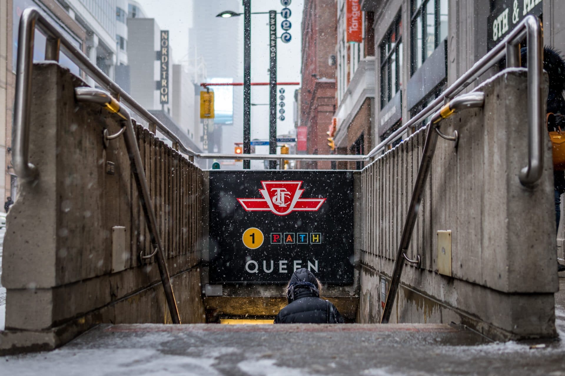 Photo of the underground entrance leading to Queen subway station in Toronto.