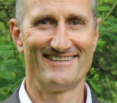 A man smiling outside.