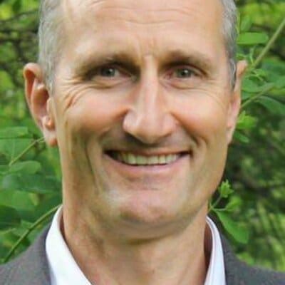 A man smiling outside.