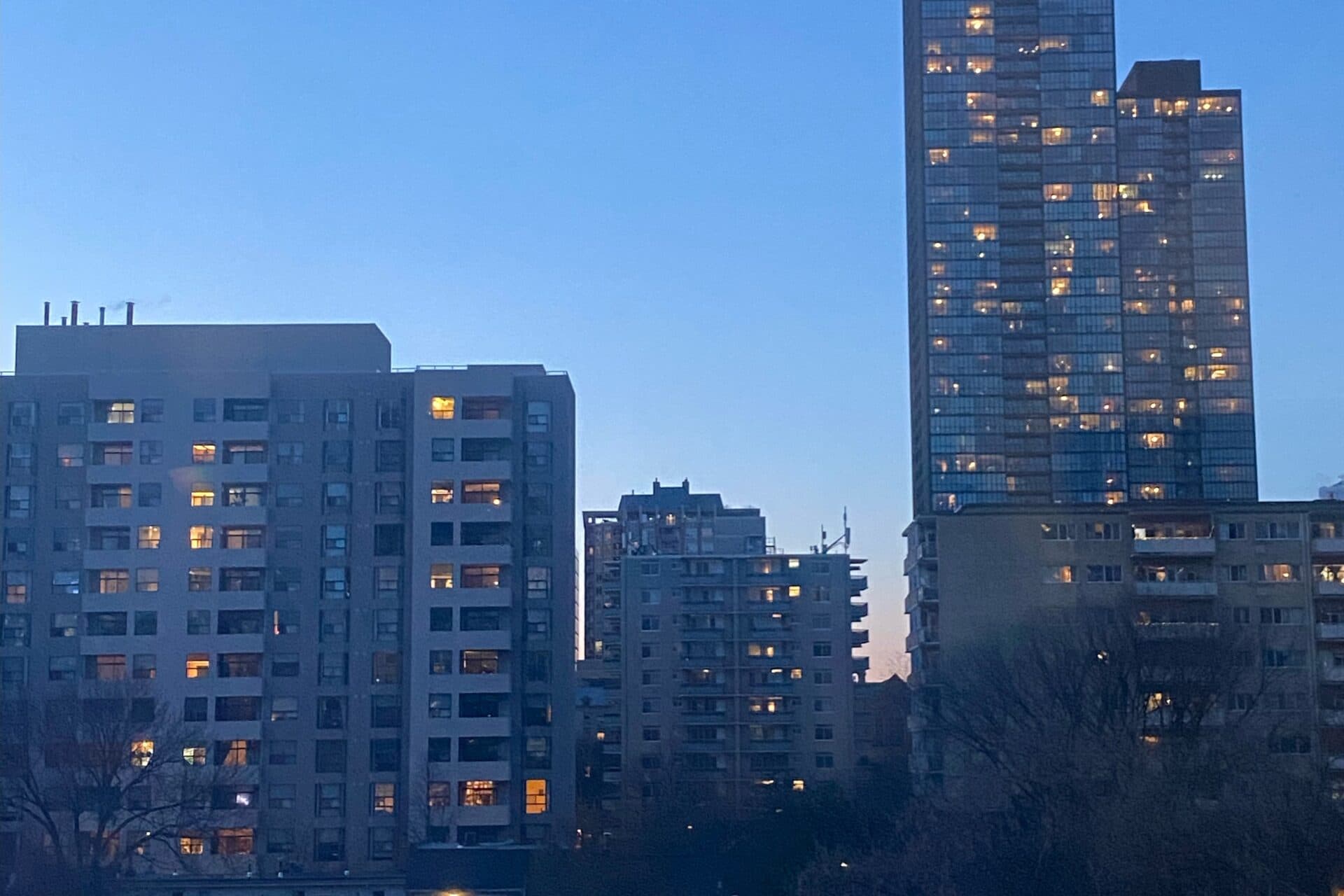 A photo of the skyline in Toronto, as the sun begins to set in the background