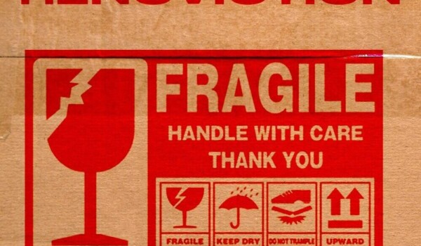 A taped box used for moving is labelled fragile.