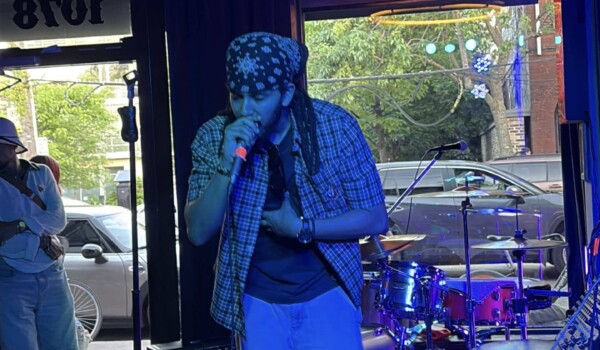An image of artist Mikey Bloom performing at Poetry Jazz Cafe.